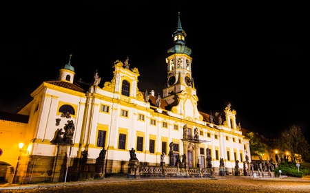 Loreta Sanctuary in Prague, with the Saints statues on the main entrance and with baroque bell towerの写真素材