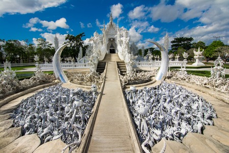Beautiful ornate white temple located in Chiang Rai northern Thailand  Wat Rong Khun  White Temple , is a contemporary unconventional Buddhist temple の写真素材