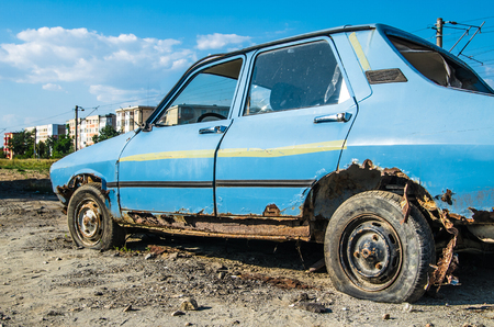 Abandoned old rusty car on the meadow の写真素材
