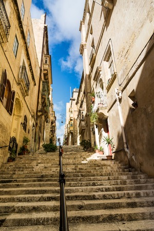 Walking street with long staircase in old town of Valletta, Malta.の写真素材