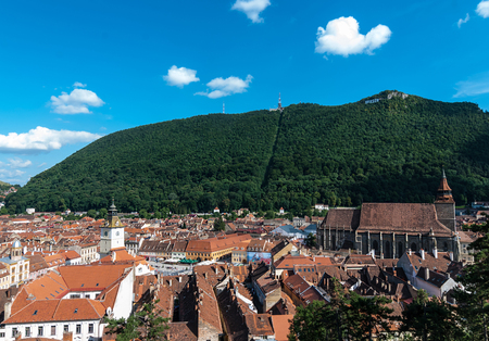 Over-view over Brasov's most important landmark, the Black Church, the largest Gothic church between Vienna and Istanbuland over Piata Sfatului and the old town.の写真素材