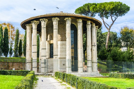 The Temple of Hercules Victor or Hercules Olivarius is an ancient edifice located in the Forum Boarium in Rome. Dating from the later second century BC the temple consists of a circular cella within a concentric ring, Corinthian columns resting on a tuff の写真素材