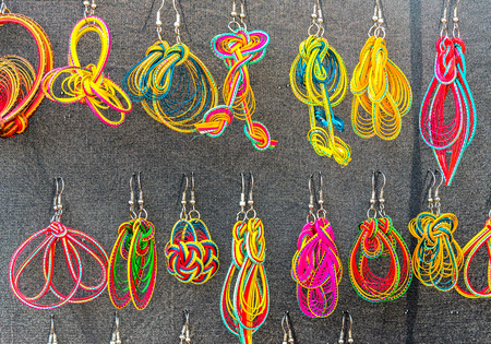 Handmade colorful of various form, decorative earrings, sold in outdoor fair marketの写真素材