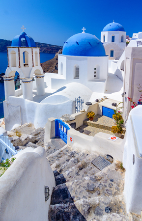 Oia town, Santorini island, Greece. Traditional and famous white houses and churches  with blue domes over the Caldera, Aegean sea.の写真素材