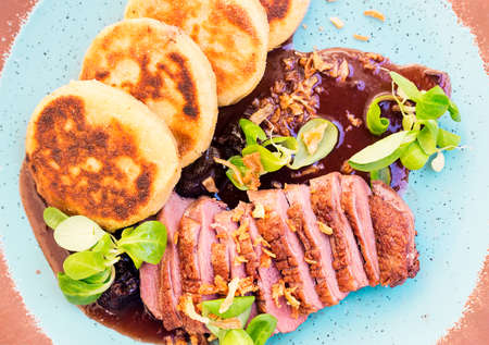 Roast duck with potato pancakes and plum sauceの写真素材