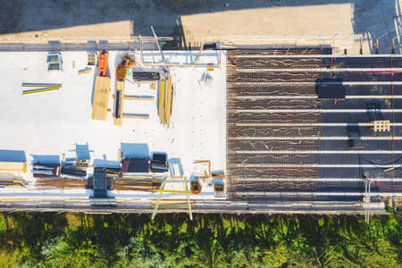 Aerial drone view on the bridge during construction. Concrete layer with material from above.