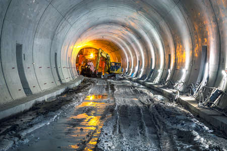 Excavator in construction place of building new railway tunnel. Railway corridor construction with machinery.の写真素材