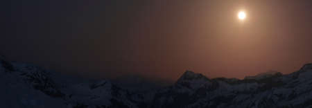 panoramic view of a mountain range win full moon light