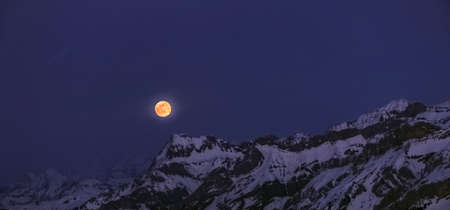 nocturnal mountainscape with rising moon