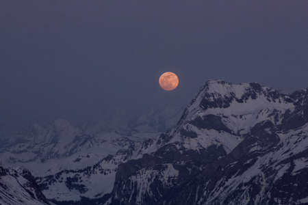 nocturnal mountain view with rising moonの写真素材