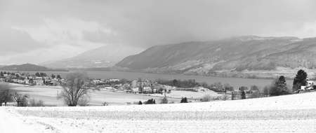 lakeshore and fields in winter timeの写真素材