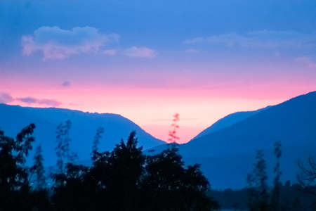 hills and trees at sunsetの写真素材