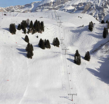 mountain slope with ski lift in winterの写真素材
