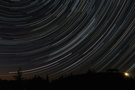 nocturnal alpine landscape with star trails