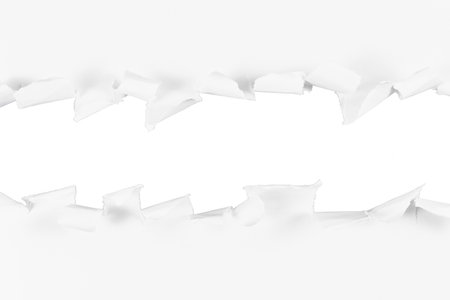 torn or ripped hole in white paper border frame or transition design element isolated on whiteの写真素材