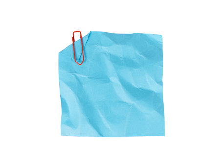 blue crumpled sticky note paper with red paperclip isolated on whiteの写真素材