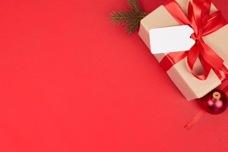 red christmas background for gift card or wishes with blank copy space cornerの写真素材