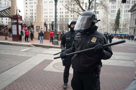 PORTLAND, OREGON JANUARY 25 2017, A police officer in riot gear after clearing the roadway of protesters of the police reaction to inauguration day protests who were blocking traffic.のeditorial素材