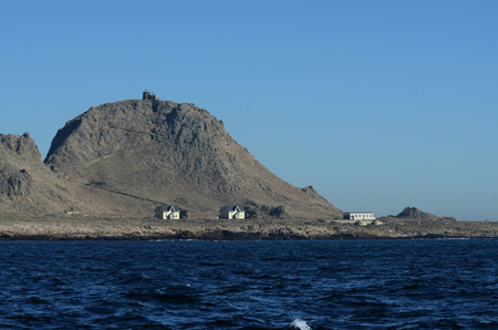 View of the Southeast Farallon Island, with the houses where scientific researchers live, as well as another building, and the Lighthouse on Tower Hillのeditorial素材