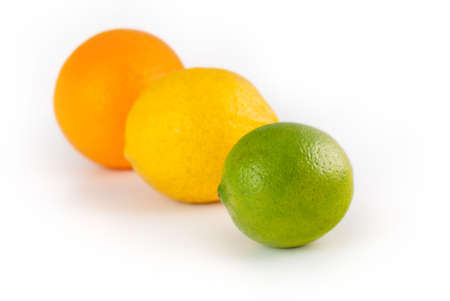 A lemon, a lime and an orange isolated on white.の写真素材