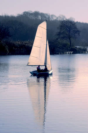sailing boat at sunset sport recreation dinghyの写真素材