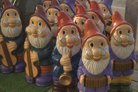 set of garden gnomes playing musical instruments for sale in garden centreの写真素材