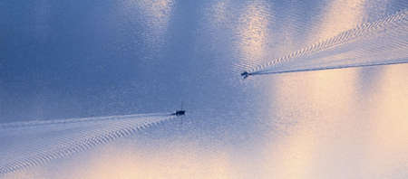 two boats on lake at sunset windermere cumbria englandの写真素材