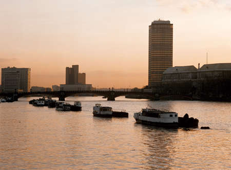 tower blocks river thames london boats moored in river