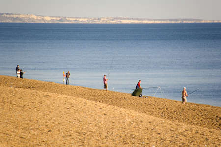 england dorset coast chesil beach fishermenの写真素材