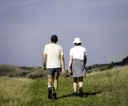 couple walking on footpathの写真素材