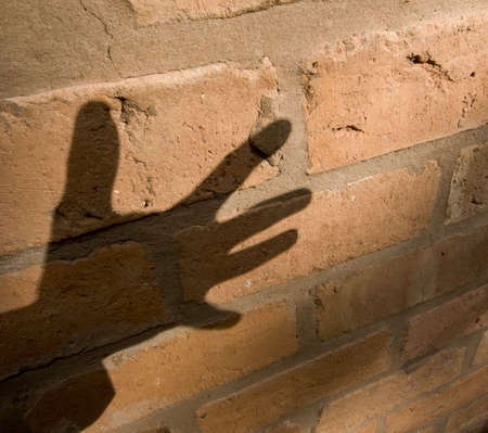 shadow of hand on brick wallの写真素材