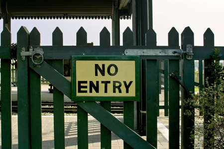 no entry sign on locked wooden gateの写真素材