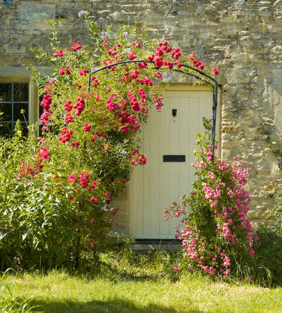 cottage with roses around doorの写真素材