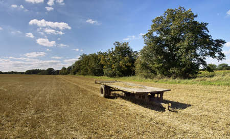 field after harvest with trailerの写真素材