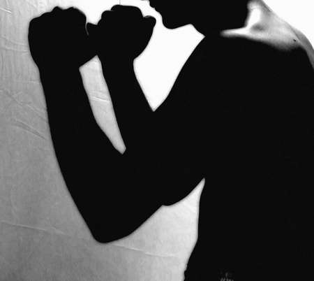young man shadow boxingの写真素材