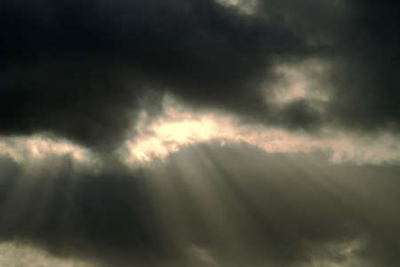 A cloudscape in the sky with clouds and shafts of light.