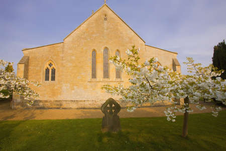 Trees in blossom at overbury church worcestershire.の写真素材