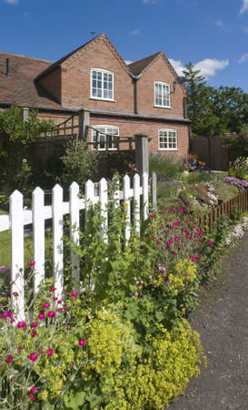 cottage with s and white picket fenceの写真素材