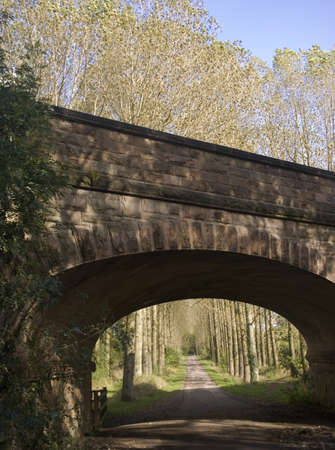 railway bridge over road country lane footpath countrysideの写真素材