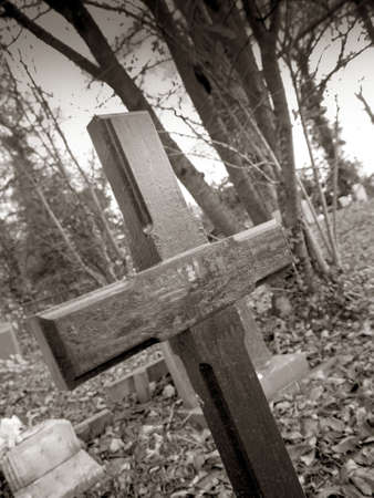a wooden cross in a cemeteryの写真素材