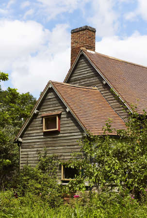 a wooden cottage with a back gardenの写真素材