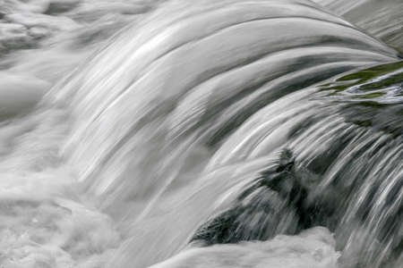 a waterfall, cascade and rapids on a riverの写真素材