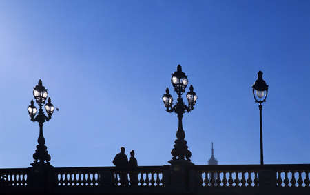 couple on the pont alexandre III bridge looking at the eiffel towerの写真素材