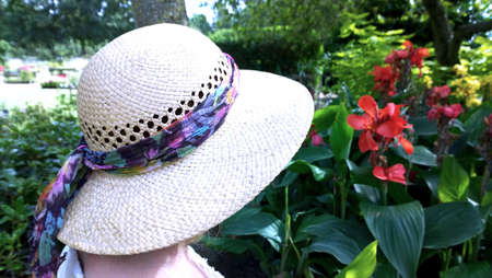 Woman in straw hat visiting stately home