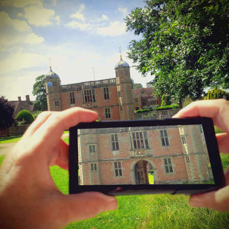 Senior woman in straw hat taking of Charlestown park stately home Warwickshire ukの素材