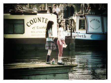 Visitors and tourists on the high street broadway village in the Cotswolds Worcestershire England UKの素材