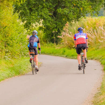 Two cyclists on country roadの素材