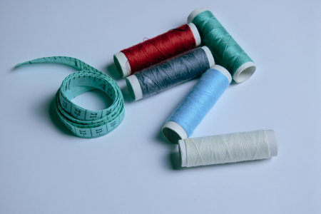 Spools of thread and measuring tape on white background. Sewing conceptの写真素材