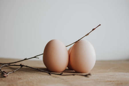 Fresh farm eggs on a wooden rustic background. Candid style on Easterの写真素材