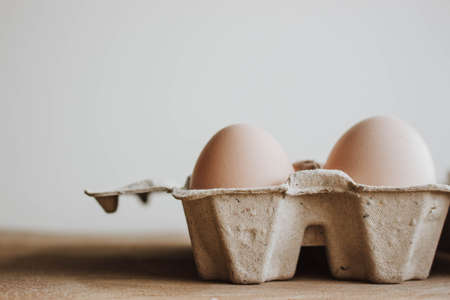 Easter raff egg. Minimal Easter concept. Craft hipster holiday package, carton boxの写真素材